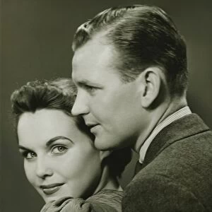Couple posing in studio, (B&W), close-up, portrait