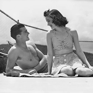 Couple relaxing on a sailboat