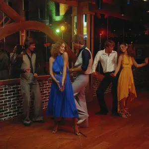 Couples dancing together at nightclub, smiling