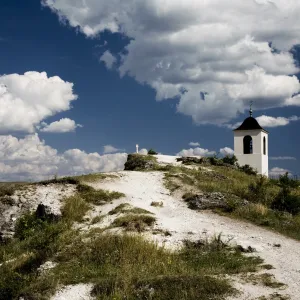 Cross and bell tower on a cliff in Orheiul Vechi