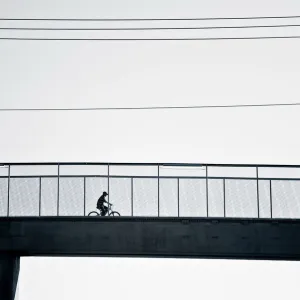 Cyclist crossing bridge