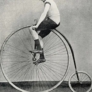 Cyclist J. H. Adams on a penny farthing bicycle, side view