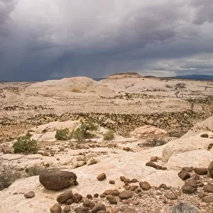 Desert Storm With Lava Boulders In The Foreground At Grand Staircase-Escalante National Monument