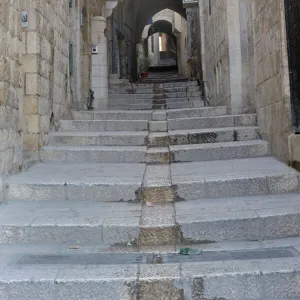 Deserted alleyway with Israeli flag hanging from a window above an archway, Muslim Quarter, Old City, Jerusalem, Middle East