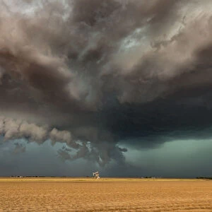 A developing tornado over nodding donkey oil pumps, Texas, USA