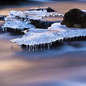 Djupin river, with ice and rocks at sunrise, Vik, Iceland