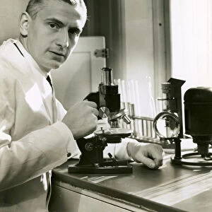 Doctor with microscope in lab