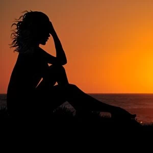 Dramatic woman watching beautiful sunset