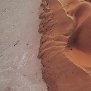 Drone image looking down on the edge of a desert dune at sunset, Abu Dhabi, United Arab Emirates