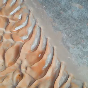 Drone shot of abstract patterns created by sand dunes, United Arab Emirates Drone shot of abstract patterns created by sand dunes, United Arab Emirates