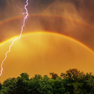 Edmond lightning with a double rainbow, Oklahoma. USA