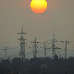 Electric power transmission lines, electricity pylons, with the setting sun, Korb near Stuttgart, Baden-Wuerttemberg, Germany, Europe
