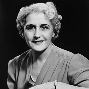 Elegant mature woman smiling, (B&W), portrait
