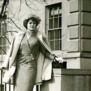 Elegant woman posing on sidewalk, (B&W)