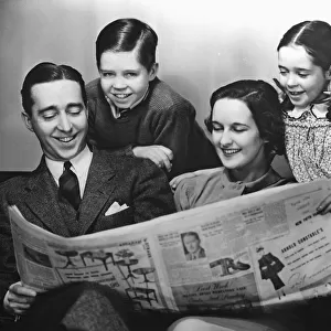 Family reading newspaper