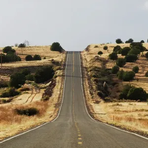 The famous road, Route 66, stretches across the Arizona desert near Seligman, NM The famous road, Route 66, stretches across the Arizona desert near Seligman, NM