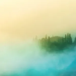 Farmhouse in the morning fog in Tuscany, Italy