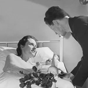 Father Visiting his Wife & their Newborn Baby in Hospital Bed