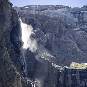 The first plane of Gavarnie waterfall with persons. Hautes Pyrenees. France. World Heritage by UNESCO, the great waterfall