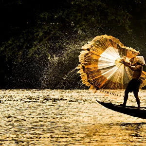 Fisherman catch fish in the river in Hue, Vietnam