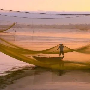 One fisherman with fishing net system, Hoi An ancient town, Vietnam One fisherman with fishing net system, Hoi An ancient town, Vietnam
