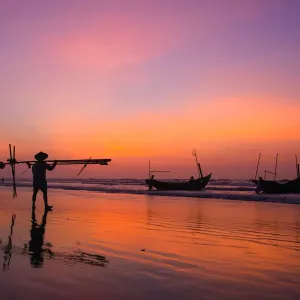 Fisherman going on the beach at dawn in Vietnam Fisherman going on the beach at dawn in Vietnam