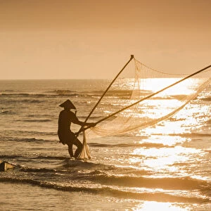 Fisherman with v-shape net in beach