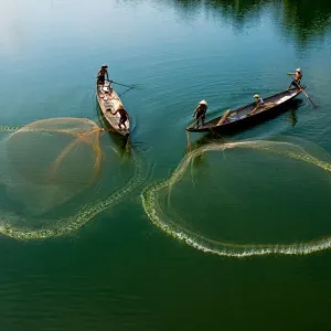 Fishermen go fishing on two boats in Hue, Vietnam Fishermen go fishing on two boats in Hue, Vietnam