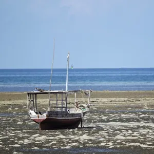 Fishing boat on the beach at low tide, near Fumba, Zanzibar, Tanzania, Africa