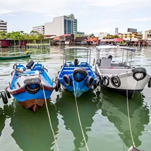 Fishing boats docked in urban harbor