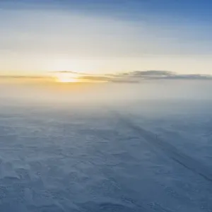 Fog and sunset over snowy road, Iceland Fog and sunset over snowy road, Iceland