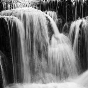 Full frame close-up of a cascade at the Tat Kuang Si Waterfalls near Luang Prabang in Laos. Natural abstract art in black and white