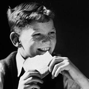 FRECKLE FACED BOY EATING SLICED BREAD