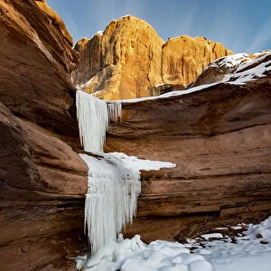 Frozen waterfalls and red rock cliffs along Colorado River near Moab, Utah, USA