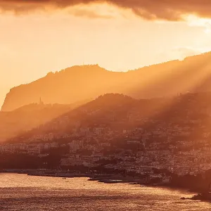 Funchal city skyline and Madeira island landscape at sunset, Portugal Funchal city skyline and Madeira island landscape at sunset, Portugal