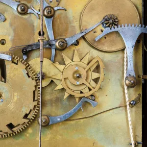 Gears and cogs in the clockwork of a historical pendulum clock, detail, regulator