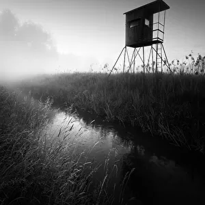 German floodplain landscape in Brandenburg with high seat on the Nuthe in black and white, Luckenwalde, Germany