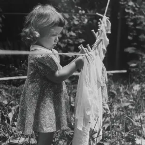 GIRL PINS LAUNDRY TO CLOTHESLINE, 1944