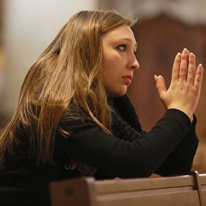 Girl, teenager, praying in a church, Menton, Alpes-Maritimes, Provence-Alpes-Cote dAzur, France
