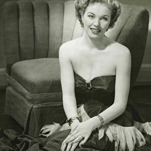 Glamorous woman posing in studio, (B&W), portrait
