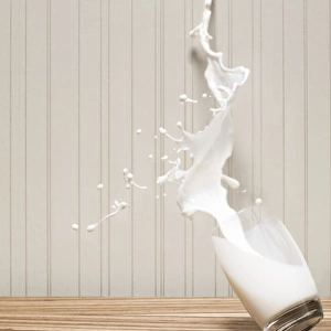 Glas of milk spilling