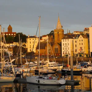 Golden early morning light shines on St Peter Port