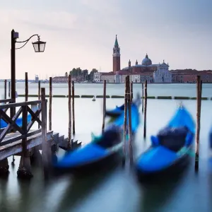 Gondolas moored by Saint Mark square with San Giorgio di Maggiore church in the background - Venice, Venezia, Italy, Europe Gondolas moored by Saint Mark square with San Giorgio di Maggiore church in the background - Venice, Venezia, Italy, Europe
