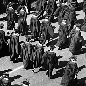 Graduates walking in rows outdoors
