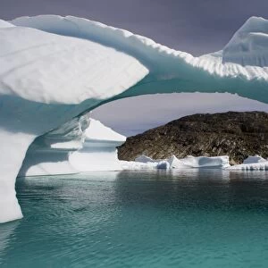 Greenland, Unartoq Island, arched icebergs floating in Unartoq Fjord