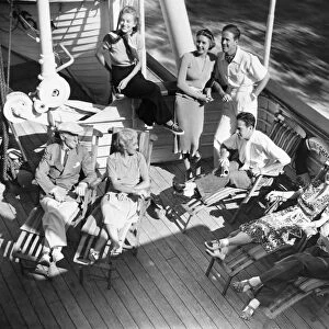 Group of people relaxing on cruiser deck (B&W), elevated view