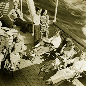 Group of people relaxing on deck of cruise ship, (B&W), (High angle view)