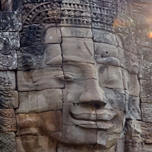Head statue at sunrise Bayon temple angkor unesco Siem Reap Cambodia