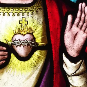 Heart and hands of Jesus Christ on an old stained glass Heart and hands of Jesus Christ on an old stained glass