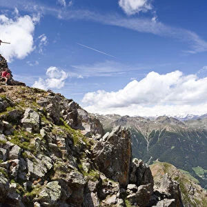 Hiker on the summit of Spitzen Kornigls Mountain, overlooking the Val dUltimo, Ultimo, Alto Adige, Italy, Europe